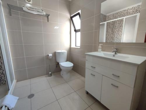 a bathroom with a toilet and a sink at Apartamento V2 Pedro - By Bedzy in Albufeira