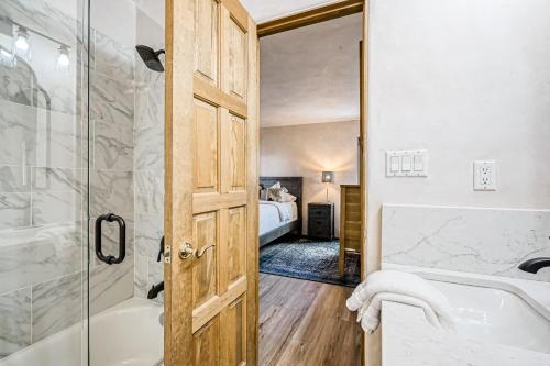 a bathroom with a shower and a tub and a sink at Casa del Encanto in Rancho Encantado