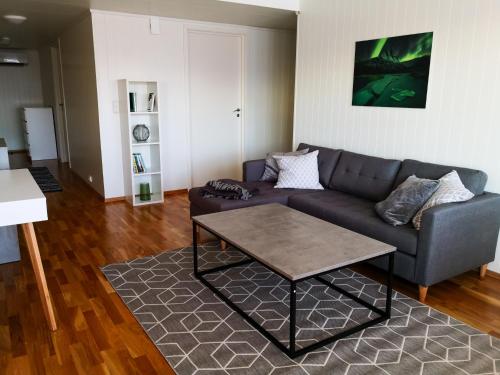 a living room with a couch and a coffee table at Destination Senja - Skaland in Skaland