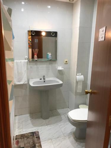 a bathroom with a sink and a toilet at PENSIÓN LA HACIENDA in Padrón