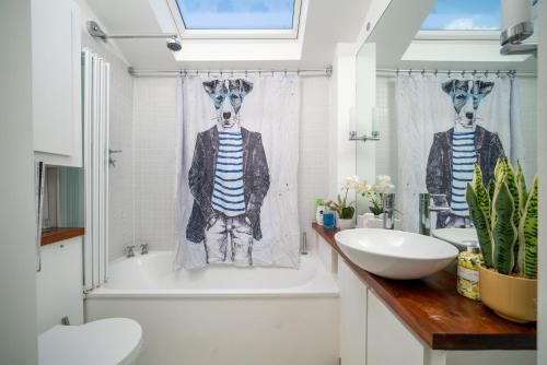 a bathroom with a skeleton in a shower curtain at Captivating apartment in Shepherds Bush in London