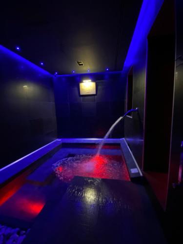 a pool with red and blue lights in a room at White albergo diffuso Ristorante & SPA in Foggia