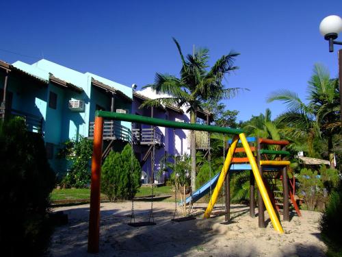 a playground with a slide in front of a building at Chalés Saint Germain in Florianópolis