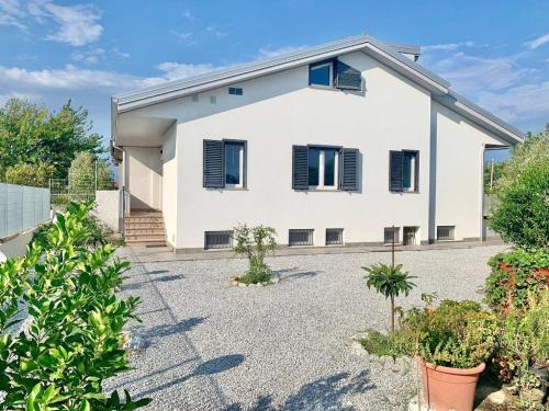 a white house with black windows and plants at DA VINCENZO in Marina di Davoli