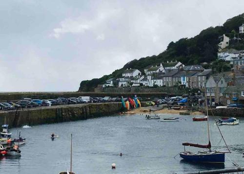 a group of boats in the water in a harbor at Stylish coastal retreat in St Ives with parking in St Ives
