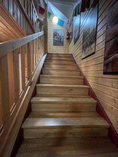 a staircase in a house with wooden walls and wooden floors at Inovecká Chata in Trenčianske Jastrabie