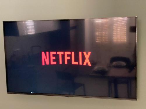 a television screen with the netflix sign on a wall at Acquamarina in Crotone