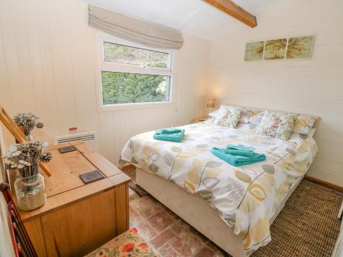 a bedroom with a large bed and a window at Hafan Dawel in Caernarfon