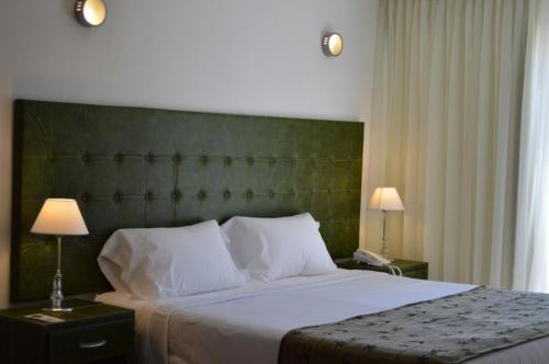 a bedroom with a large bed with a green headboard at Hotel Ríomío HABILITADO in Sauce Viejo