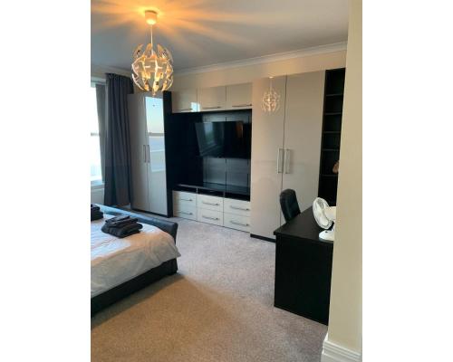a bedroom with a bed and a desk and a television at Marley Mansions Apartment - Egremont Promenade - 42 in Wallasey