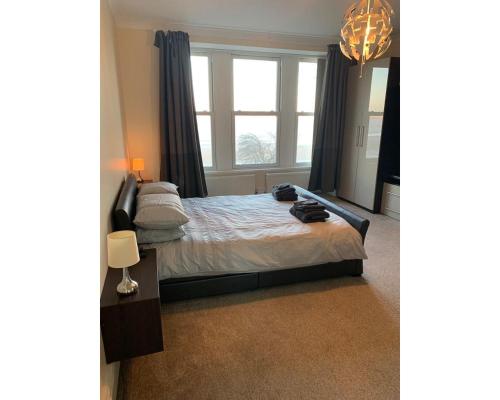 a bedroom with a bed with a large window at Marley Mansions Apartment - Egremont Promenade - 42 in Wallasey
