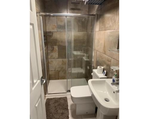 a bathroom with a shower and a toilet and a sink at Marley Mansions Apartment - Egremont Promenade - 42 in Wallasey