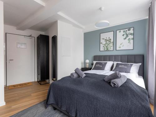 a bedroom with a large bed with towels on it at Limehome Essen Kettwiger Straße in Essen