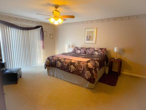 a bedroom with a bed and a ceiling fan at Windrock Retreat in Oliver Springs