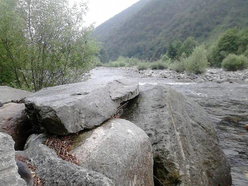 a group of large rocks on the side of a river at B&B Il Castello Lago Maggiore con TERRAZZA in Cossogno