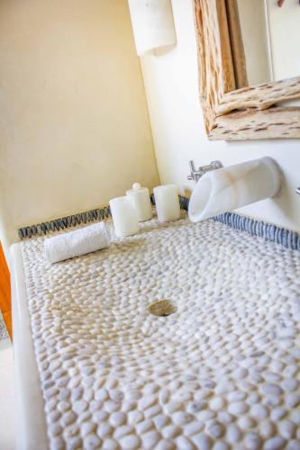 a bathroom with a sink and a toilet at Irekua Beach House Ixtapa in La Union de Isidoro Montes de Oca