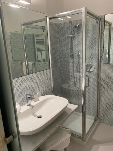 a bathroom with a sink and a shower at La Casa di Alessia in Camogli