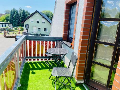a patio with a table and chairs on a balcony at Georgenberg in Spremberg