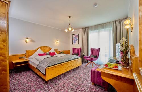 a hotel room with a bed and a desk at Landhotel Schneider in Riedenburg