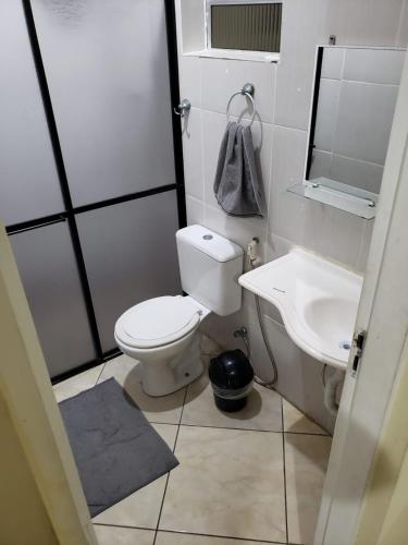 a bathroom with a toilet and a sink at Mayda hostel in Praia Grande