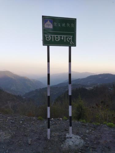 a sign on the top of a mountain at Orange sky home stay gadaGushaini near jibhi in Jibhi