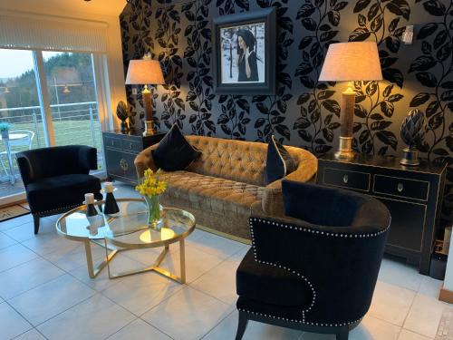 a living room with a couch and chairs and a table at Ayrs and Graces - Luxury Bed and Breakfast in Ayr