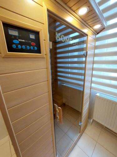 a walk in shower in a room with a door at Businessapartments Klosterneuburg in Kritzendorf