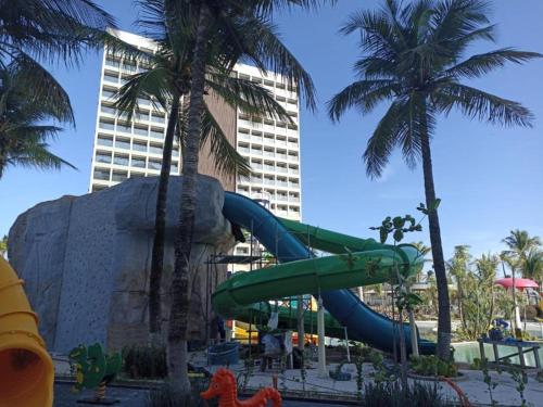 a water slide at a resort with palm trees at Salinas Premium Resort in Salinópolis