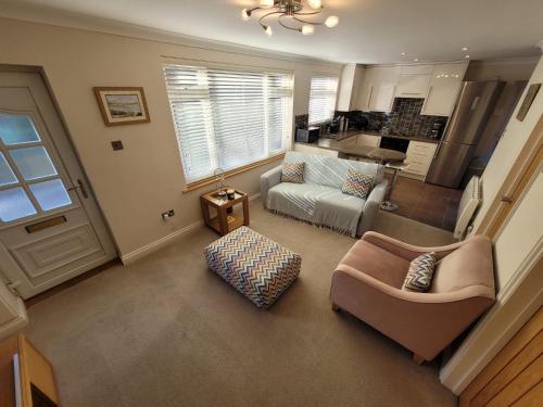 a living room with a couch and a table at Captivating 2 bedroom bungalow in mumbles in Swansea
