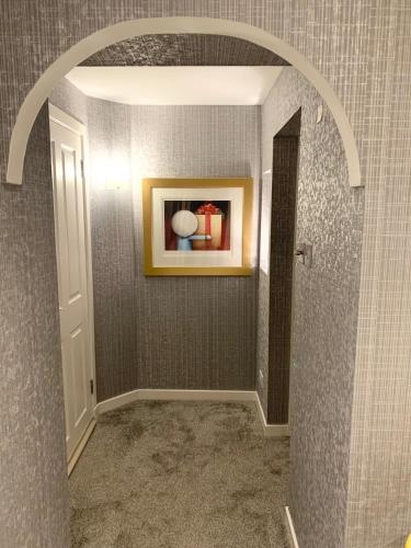 an archway in a room with a painting on the wall at Ayrs and Graces - Luxury Bed and Breakfast in Ayr