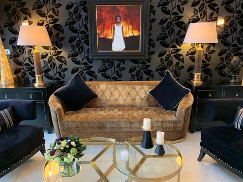 a living room with a couch and a table at Ayrs and Graces - Luxury Bed and Breakfast in Ayr