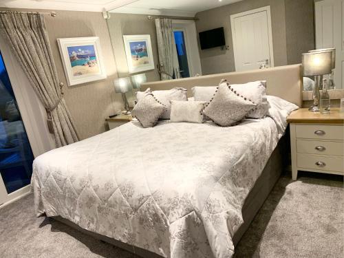 a bedroom with a large white bed with pillows at Ayrs and Graces - Luxury Bed and Breakfast in Ayr