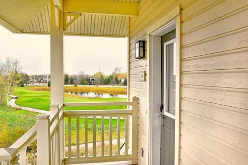 a door to a porch with a view of a golf course at Spacious Blue Mountain 2 Storey - Wifi, Pool, Close to the Village & Golf in Blue Mountains