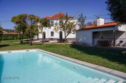 a swimming pool in front of a house at 12 Casa d'Avó in Albergaria-a-Velha