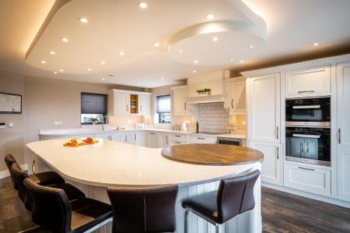 a kitchen with a round table and chairs at Cleabarrow View in Windermere