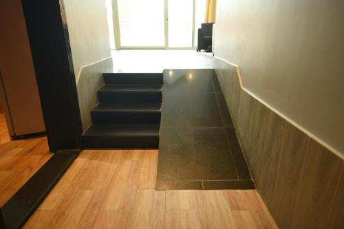 a stair case with a glass table in a room at Hotel & Resort Golden Marina Yanbu in Yanbu