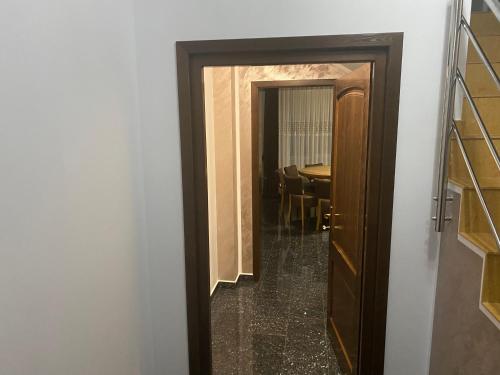 a door leading into a dining room with a table at Villa Mery in Moisei