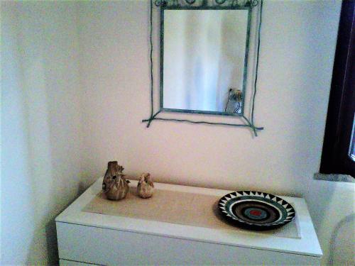 a mirror sitting on top of a toilet in a bathroom at Appartamento nel cuore di Villasimius 1 piano in Villasimius