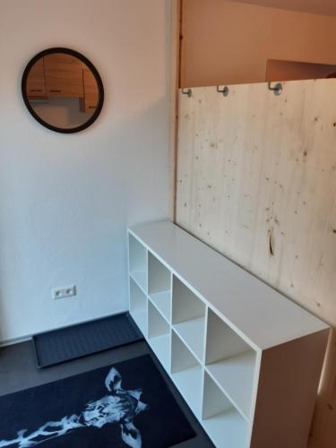 a room with a white shelf and a mirror at Your BaseCamp! in Roppen