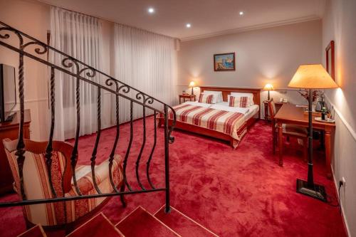 a hotel room with a staircase leading to a bedroom at Hotel Capital with private wellness in Nitra