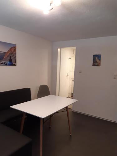 a white table in a room with two chairs at Your BaseCamp! in Roppen