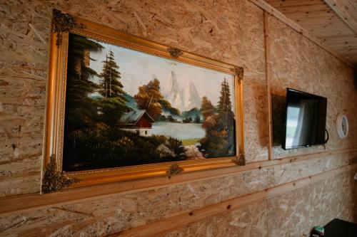 a painting hanging on a wall in a room at Bujtina Vjosa in Memaliaj