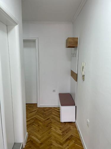a small room with a bench in the corner of a room at Stan centar ns in Novi Sad
