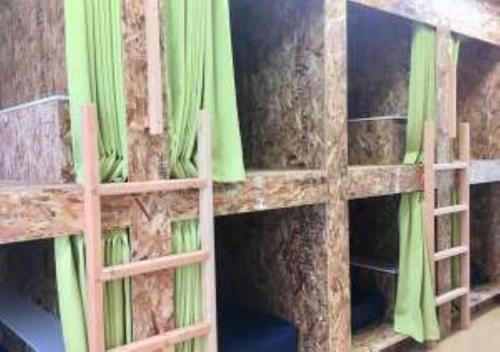a wooden book shelf with green curtains on it at Agri Museum NADA - Vacation STAY 09937v in Minamiawaji