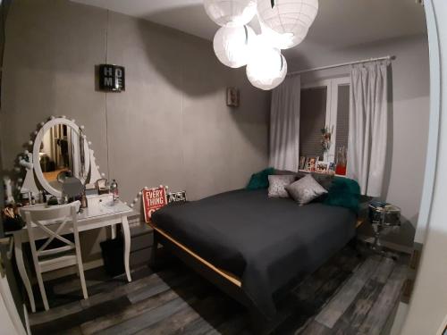 a bedroom with a bed and a dressing table and a mirror at Lux-house Braniewo in Braniewo