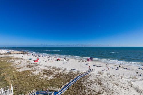 a beach with a lot of people and the ocean at San Carlos Unit 607 in Gulf Shores