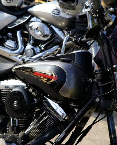 a close up of a black motorcycle parked at La pacheca in Lazise