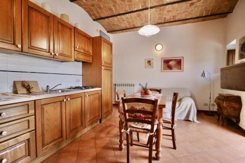 a kitchen with a table and a sink and a table and chairs at Alle Vecchie Querce in Fontecchio