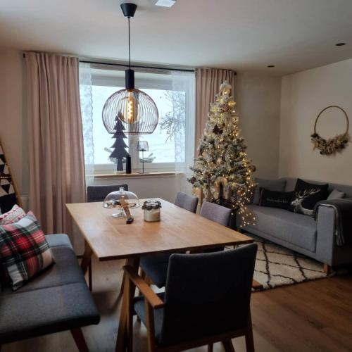 a living room with a christmas tree and a table at Lieblingsplatz - Ski in und Ski out in See