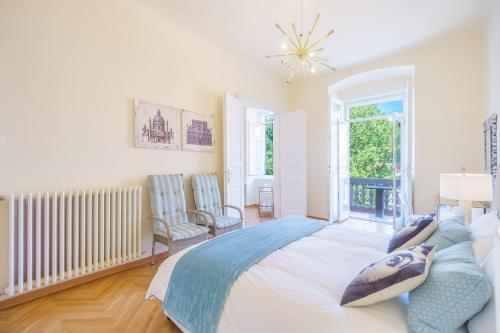 a bedroom with a large bed and a window at James Joyce Luxury Apartment in Trieste